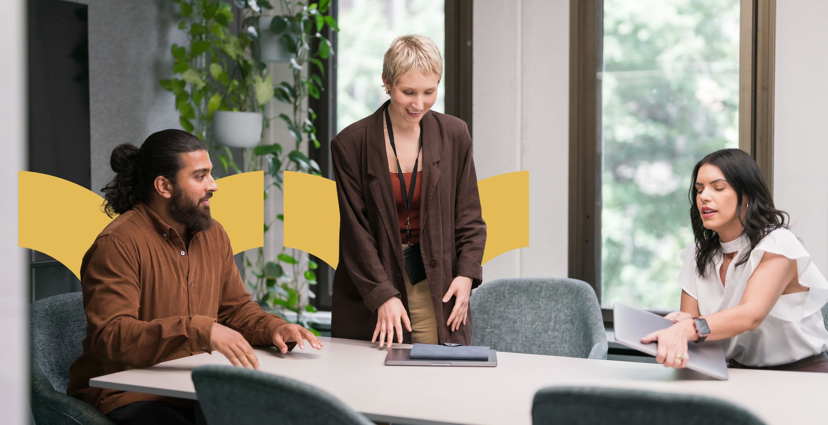 Three people talking in a meeting room