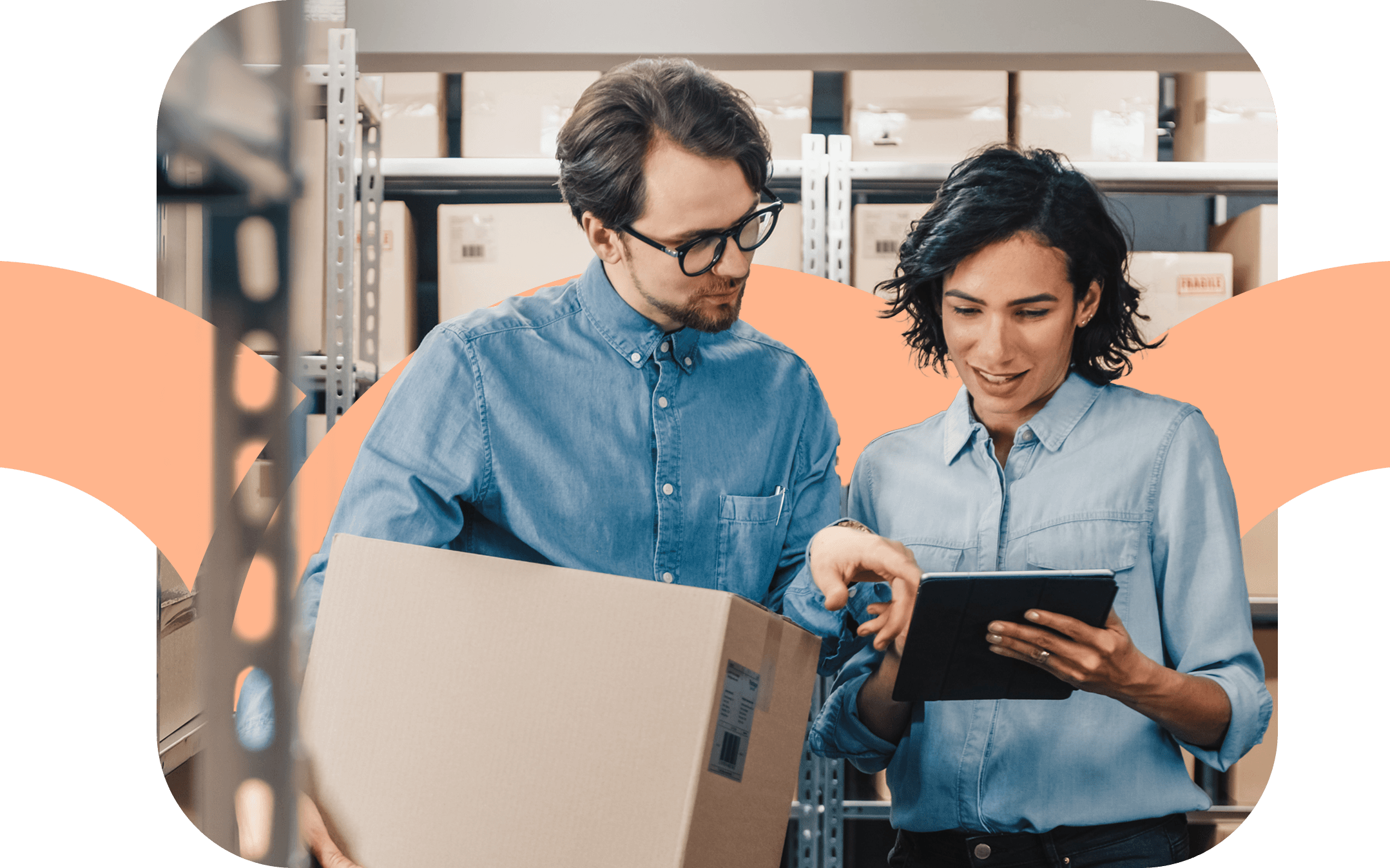 A man and woman looking at a tablet in a warehouse